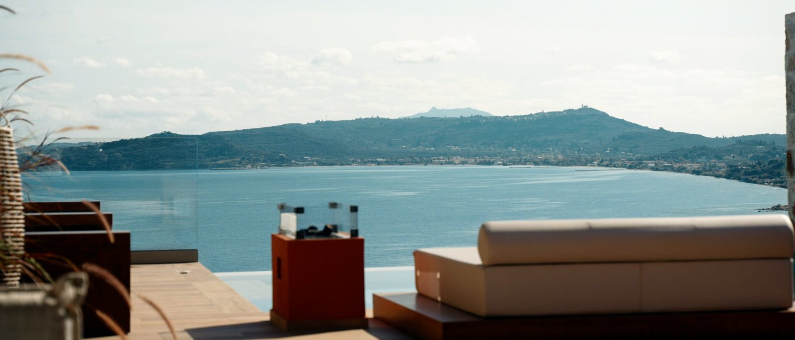 A sea terrace with a made daybed, empty