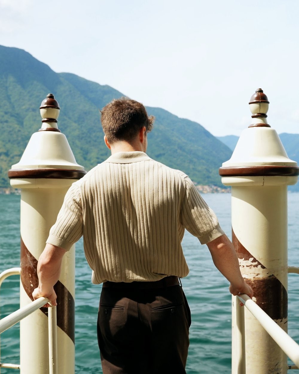 A man at a landing stage, looking out over the water